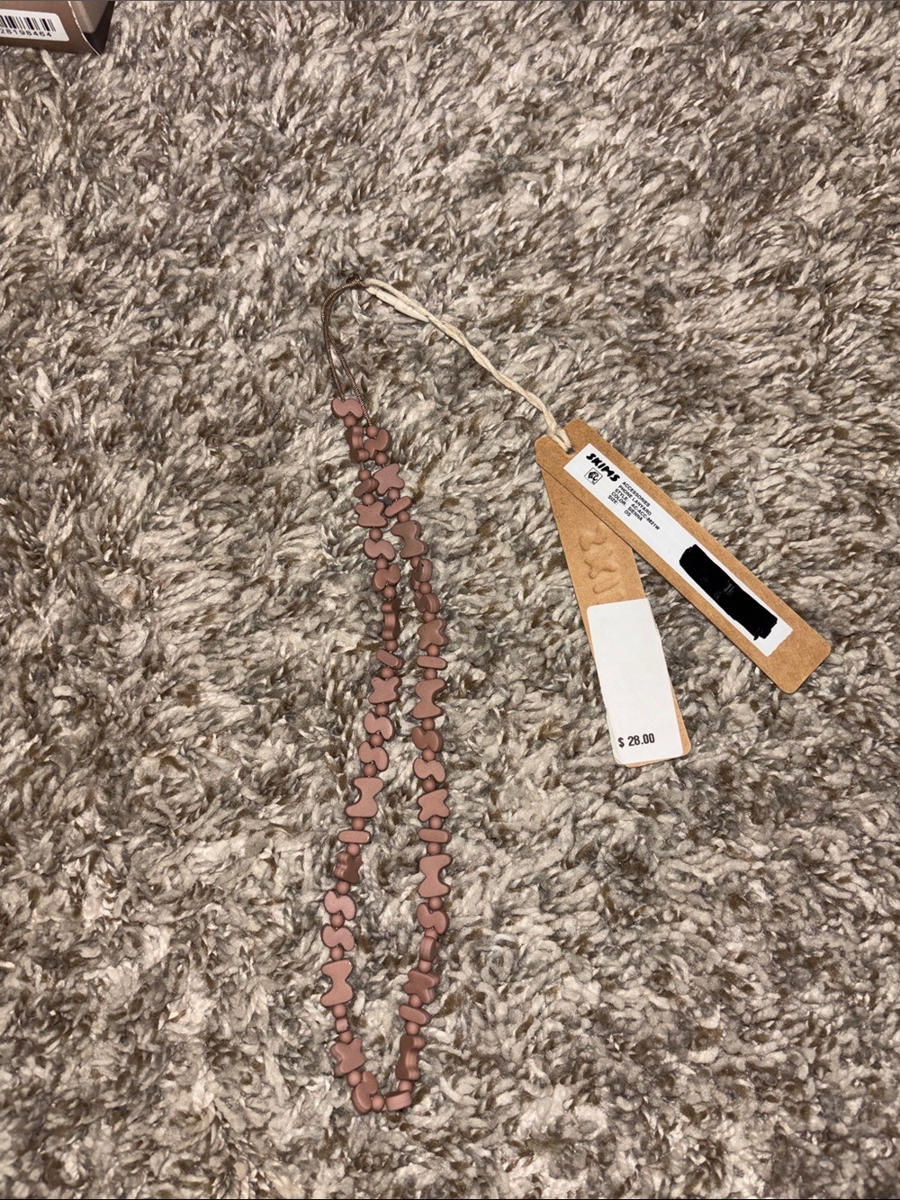 SKIMS pink phone lanyard strap